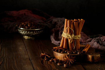 Cinnamon sticks tied with a rope on a wooden table. Selective focus. Cinnamon sticks tied in a pile on a wooden table.