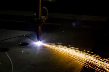 Plasma cutting of metal with a cnc. Plasma cutting machine cutting steel sheet. Laser cutter in...