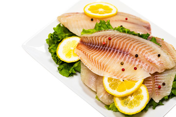 Whitefish Tilapia Fish Raw Fillet Isolated on White Background. Selective focus.