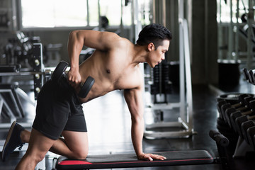 Obraz na płótnie Canvas dumbbell workout on bench in gym