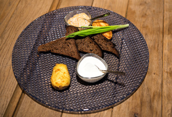 Restaurant serving of rye bread and pike caviar with potato, green onion and cream. Rich luxury...
