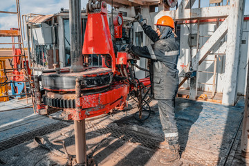 Offshore oil rig worker prepare tool and equipment for perforation oil and gas well at wellhead...