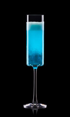 Glass for blue champagne with splashes isolated on black background.