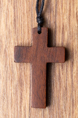 wooden cross on wooden background