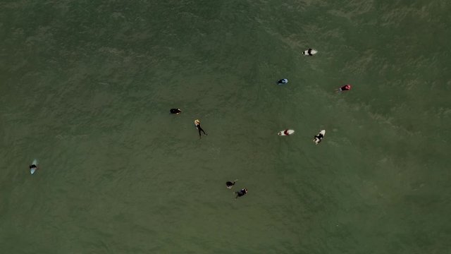 Aerial view of surfers and bodyboarders waiting for waves. Biarritz, France.