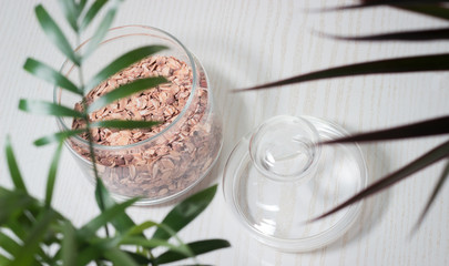 oatmeal muesli with raisins in a glass bowl on a white background
