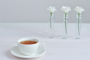 One small cup of tea with white Eustomas.Valentine card.Template greeting card for Valentine's Day. Spring card for Mother's Day, Women's Day.copy space. March 8.breakfast for loved ones