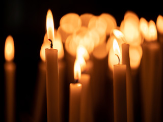 Image of many burning candles with shallow depth of field