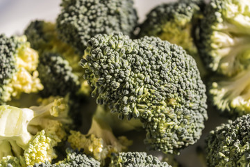 Green broccoli (Brassica oleracea) inside the plate closeup, broccoli florets ready to be cooked, healthy diet - Image