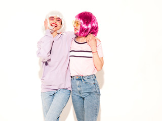 Two young sexy smiling hipster girls in wigs and red lips.Beautiful trendy women in summer...
