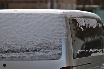 snow on the car body on a frosty winter morning