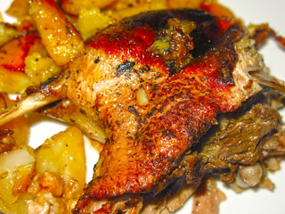roast duck with potatoes on a plate