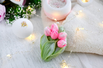 Springtime spa composition with tulips soap. bath bombs, towel on light background. Mothers day, Women day or  wedding lifestyle concept.  8 March greeting card