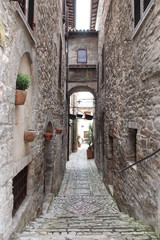 steps leading down to narrow wall lined street in old city
