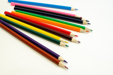 set of colored pencils on a white background