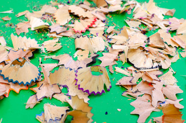 color pencil shavings on green background
