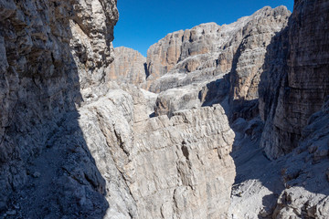 Fixed-rope Route, climbing a via ferrata route. Italian Alps. Mountain tourism in the Dolomites. Region Brenta, Italy.