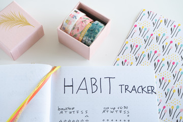 bullet journal - macro of habit tracker decorated with washi tape and a jewelry box