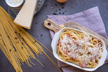 Traditional spaguetti carbonara with pancetta, egg and parmesan cheese. Italian cuisine. Top view.