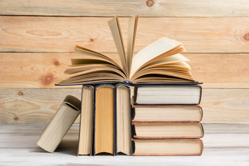 Open book, hardback books on wooden table. Back to school. Copy space