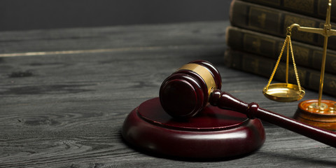Obraz premium Law concept - Open law book with a wooden judges gavel on table in a courtroom or law enforcement office isolated on white background. Copy space for text.