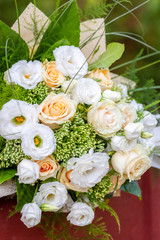 Rich bunch of white and cream rose, Eustoma flowers and green leaf. Bridal vintage bouquet. Floral backdrop
