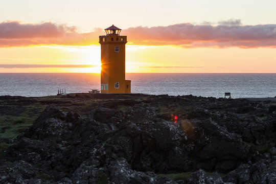 Svortuloft Lighthouse, Hellissandur in The Snaefellsjokull National Park, Snaefellsbaer, Iceland. Orange colorful sunset, good sunny weather.
