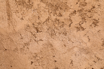 Crumbling texture of traditional brown mud wall