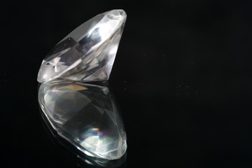 Artificial diamonds lying in the sand photographed in the studio with flash light