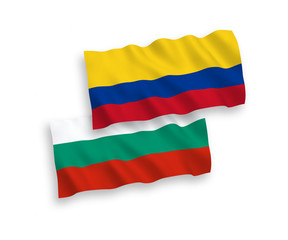 National vector fabric wave flags of Bulgaria and Colombia isolated on white background. 1 to 2 proportion.