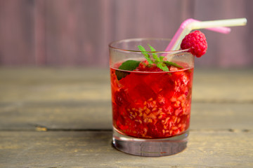 Glass of fresh strawberry smoothie and fresh strawberries on pink wooden background. Healthy food and drink concept.