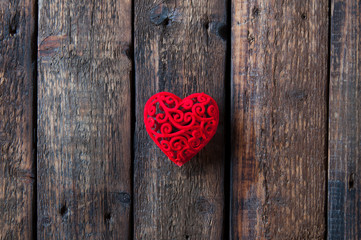 Little red heart on a wooden background. Love