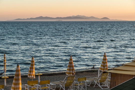 beach at sunset with orange sky in Follonica