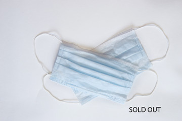 Text phrase Sold out on a white background with protective masks. Novel coronavirus 2019-nCoV,...