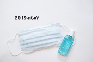 Respiratory mask and antibacterial hand gel on white background.Virus prevention and treatment:...