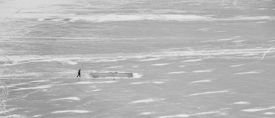skating on frozen lake alone in winter