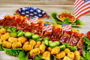 Party table with delicious appetizer and US flag.