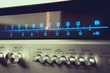 Classic radio tuner panel close-up. Black background