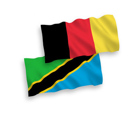 National vector fabric wave flags of Tanzania and Belgium isolated on white background. 1 to 2 proportion.