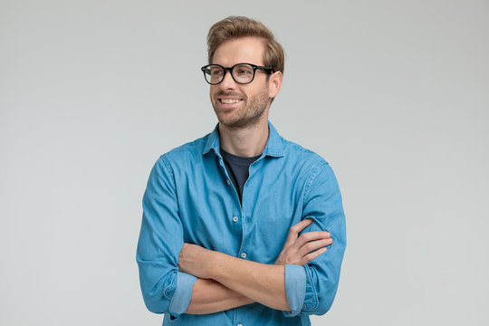 Proud Young Casual Man Crossing Arms And Smiling