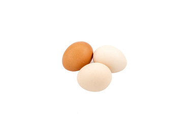 White and brown eggs on white ground