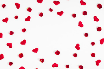 Elegant composition for Valentine's Day. Red hearts, rose petals on white background. Valentine day, 8th march, Mother day background. Love concept. Flat lay, top view, copy space