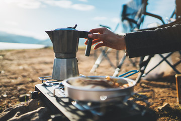 moka coffee pot outdoor, campsite morning picnic lifestyle, person cooking hot drink in nature camping, cooker prepare breakfast, tourism recreation outside - obrazy, fototapety, plakaty
