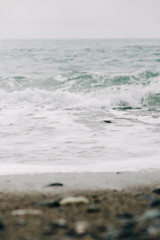 the sea wave arrives on the sandy shore . beautiful natural background