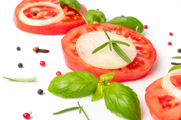 Big tomato slices, fresh herbs and spices isolated