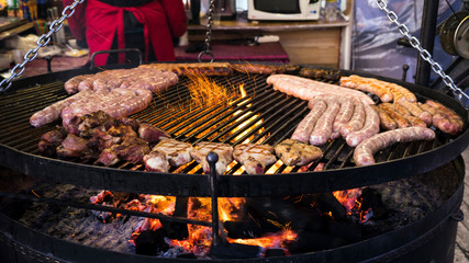 Sausages and steaks  on a large grill.