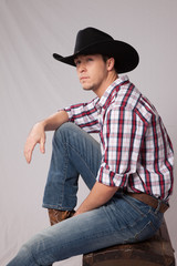 Pensive Cowboy in hat and plaid shrit