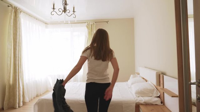 Tired woman falling on bed.