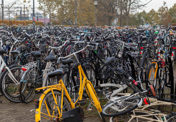 Fototapeta na wymiar Bicycle parking,bunch of different bicycles the favourite type of transport in Netherlands