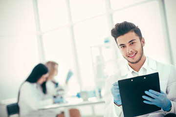 close up. a scientist doing writes the results of an experiment